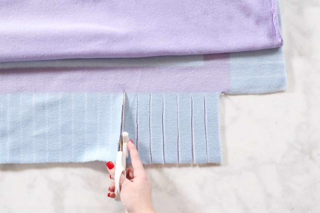 How to Make a No-Sew Fleece  Blanket, a tutorial featured by top US sewing blogger, Sweet Red Poppy.