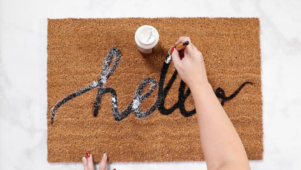 Apply Mod Podge layer to custom diy doormat for extra protection