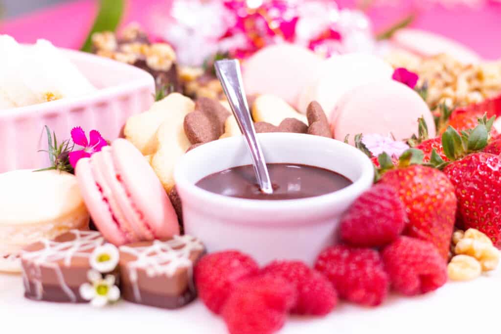 Dessert Charcuterie Board by popular Utah craft blog, Sweet Red Poppy: image of a dessert charcuterie board filled with fruit, cookies, chocolate sauce, chocolate candy, nuts, and macaroons. 