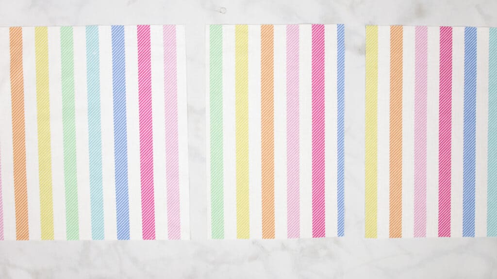 How to Make an Envelope Pillow Cover With One Piece of Fabric by popular Utah sewing blog, Sweet Red Poppy: image of cut rainbow stripe fabric. 