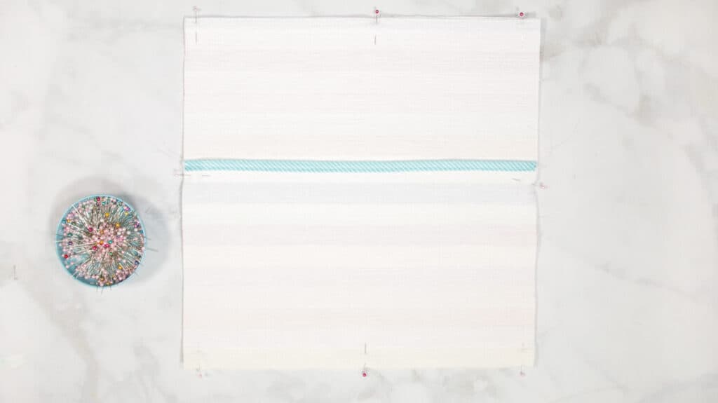 How to Make an Envelope Pillow Cover With One Piece of Fabric by popular Utah sewing blog, Sweet Red Poppy: image of pinned rainbow stripe fabric. 