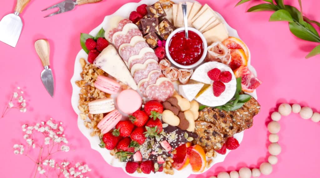 Valentine's Day Charcuterie Board by popular Utah craft blog, Sweet Red Poppy: image of a charcuterie board filled with meat, crackers, cheeses, macaroons, nuts, and fruit. 