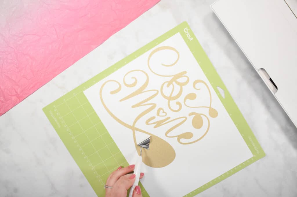 Cricut Shadow Box by popular US craft blog, Sweet Red Poppy: image of  a woman making a gold glitter vinyl design. 