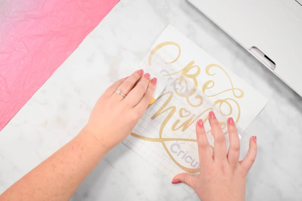 Cricut Shadow Box by popular US craft blog, Sweet Red Poppy: image of  a woman using a scraper tool on a vinyl design. 