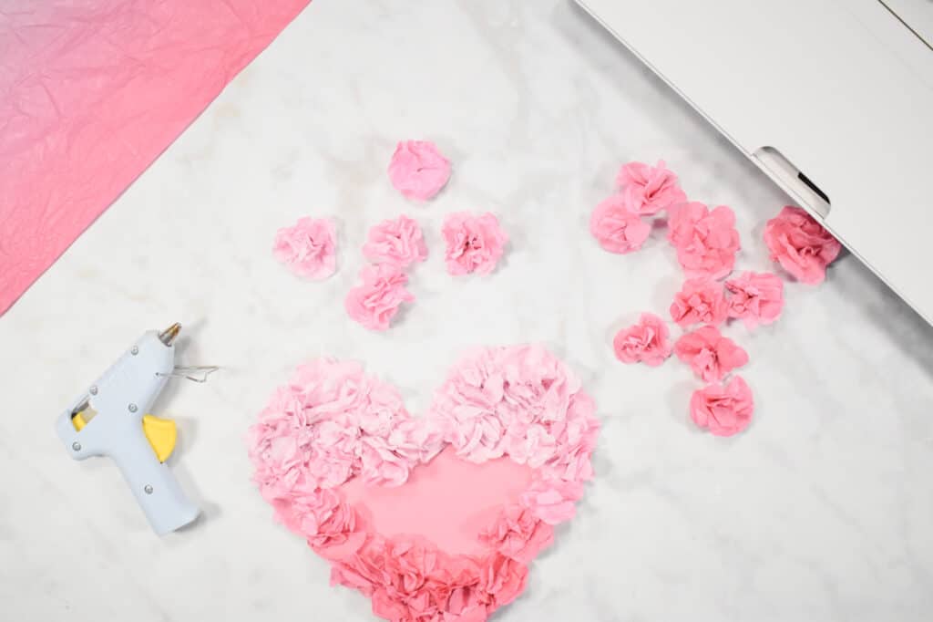 Cricut Shadow Box by popular US craft blog, Sweet Red Poppy: image of  a pink paper heart with paper flowers hot glued on to it. 