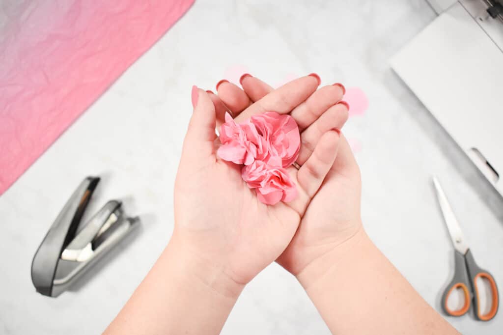 Cricut Shadow Box by popular US craft blog, Sweet Red Poppy: image of  a woman holding paper flowers in her hands. 