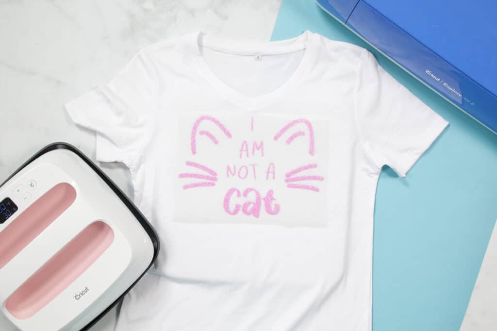 I'm not a cat SVG file | SVG Files by popular US craft blog, Sweet Red Poppy: image of a I am not a cat t-shirt next to a blue Cricut machine. 