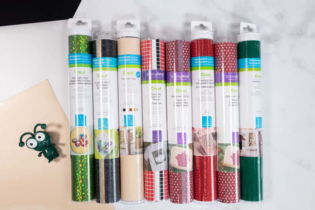 Cricut Mystery Box by popular Utah craft blog, Sweet Red Poppy: image of a green Cricut cutie next to rolls of Cricut iron-on vinyl. 