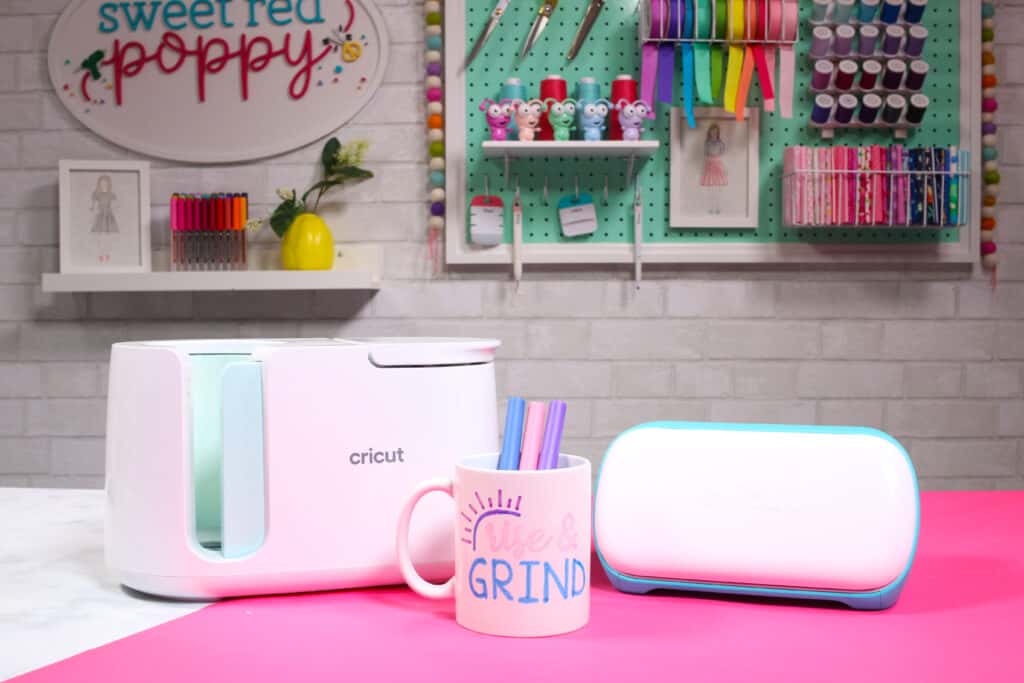 Cricut Infusible Ink Pens by popular US craft blog, Sweet Red Poppy: image of a white ceramic mug containing Cricut infusible ink pens and resting next to a Cricut mug press. 