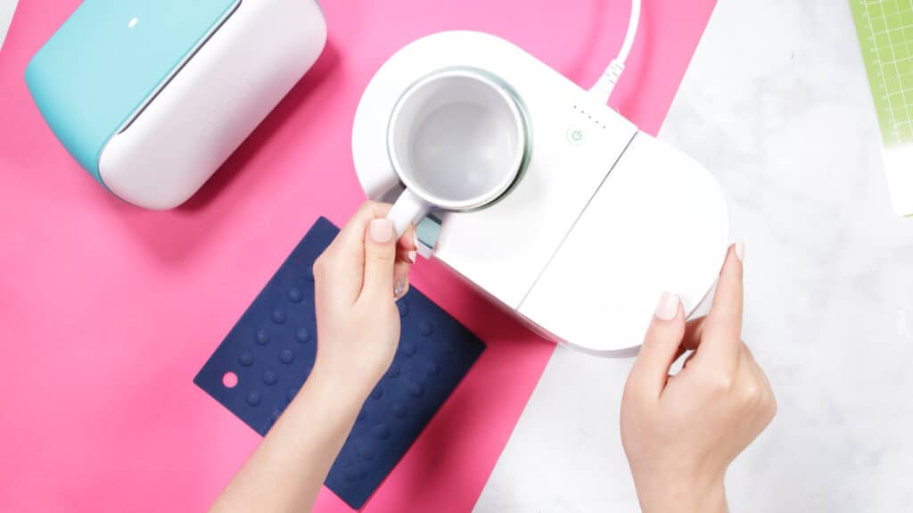 Cricut Infusible Ink Pens by popular US craft blog, Sweet Red Poppy: image of a woman using a Cricut mug press. 