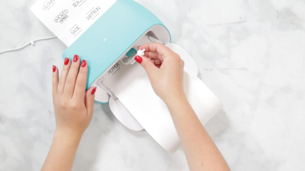 Insert Fine-Point Blade |Kitchen Organization Hacks by popular US craft blog, Sweet Red Poppy: image of a woman inserting a fine-point blade. 