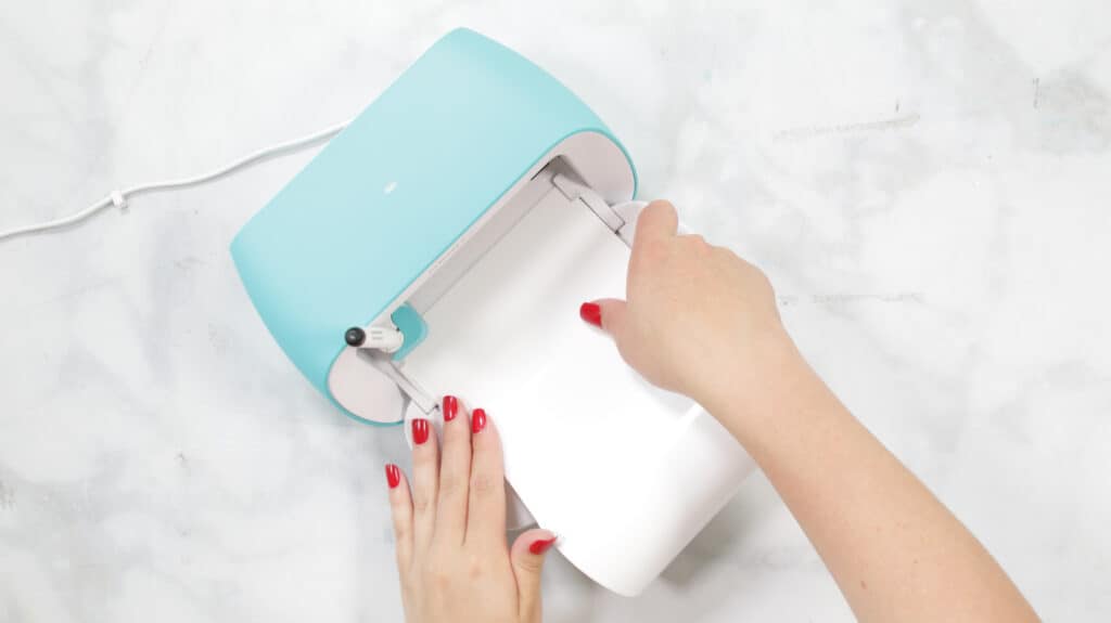 Load Smart Material |Kitchen Organization Hacks by popular US craft blog, Sweet Red Poppy: image of a woman loading Cricut smart material. 