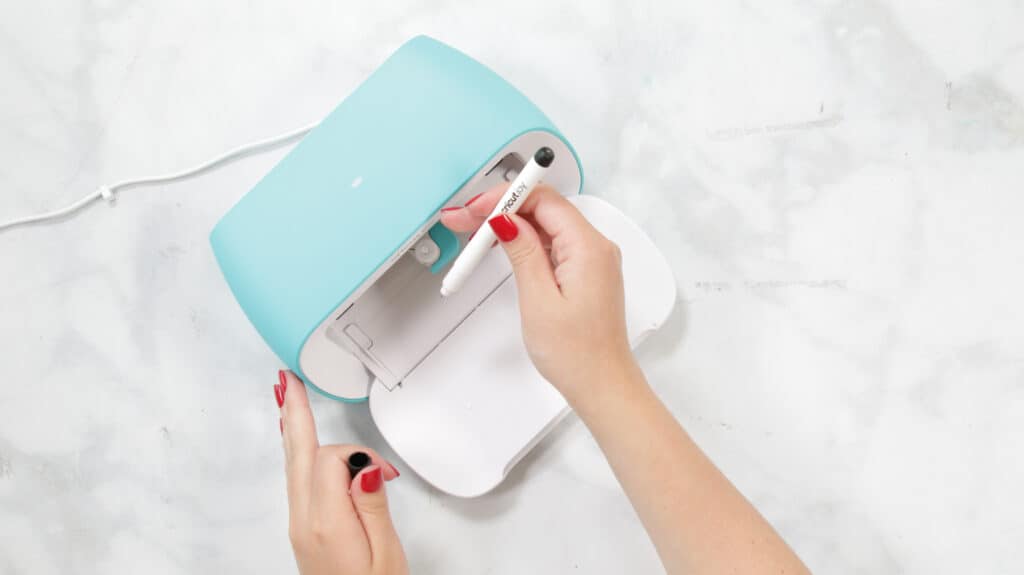 Insert Pen |Kitchen Organization Hacks by popular US craft blog, Sweet Red Poppy: image of a woman inserting a Cricut Joy pen. 