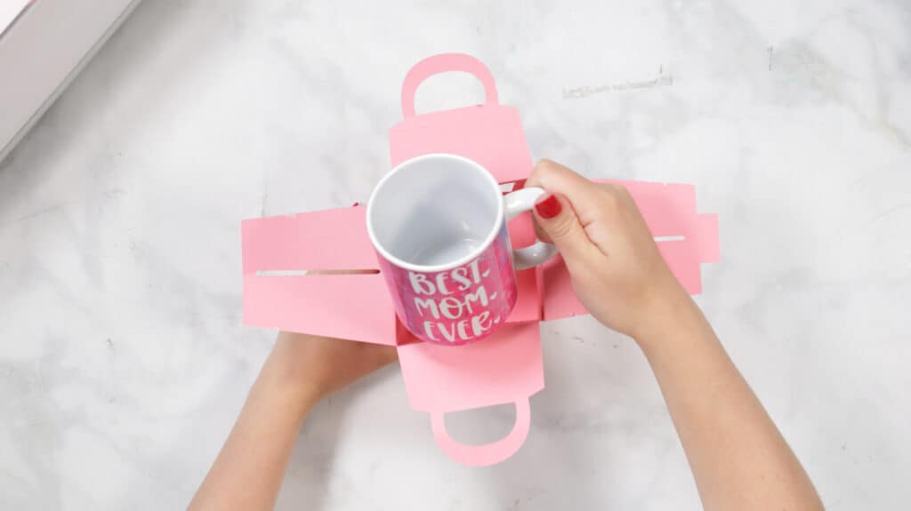 Inser Mug |Mother's Day Mug by popular US craft blog, Sweet Red Poppy: image of a woman putting a mug in a cardboard gift box. 