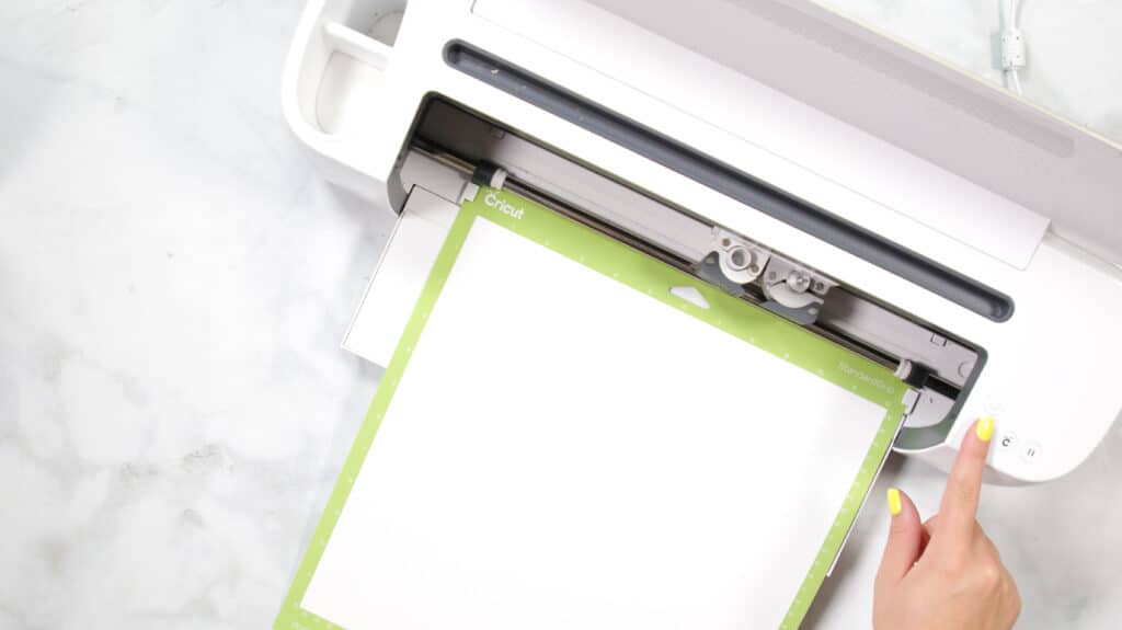 DIY 4th of July Wreath by popular US craft blog, Sweet Red Poppy: image of a woman using a Cricut machine. 