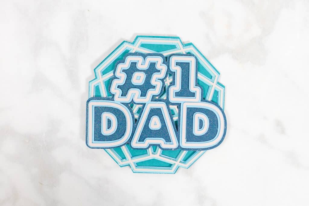 DIY Father's Day Card by popular US craft blog, Sweet Red Poppy: image of a #1 Dad cutout and mandala cutout. 