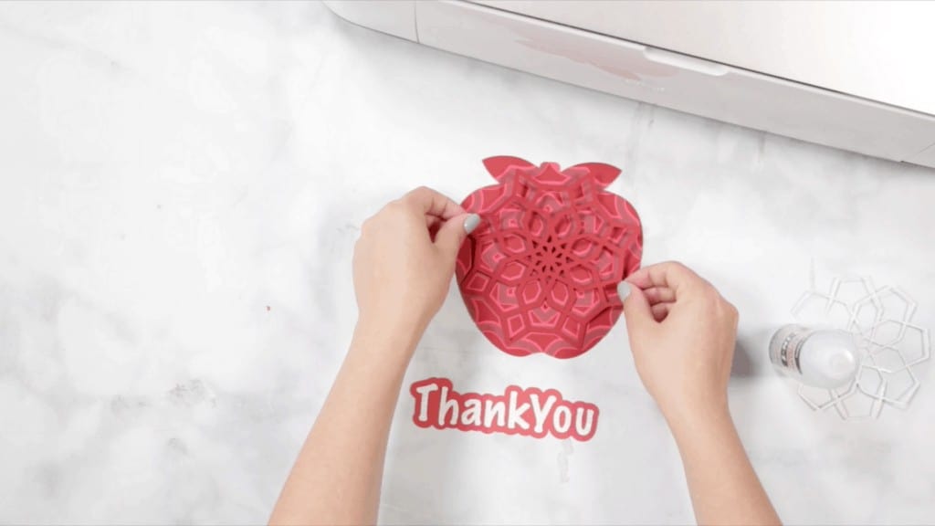 Apple Mandala by popular US craft blog, The Sweetest Thing: image of a woman assembling a layered apple mandala. 