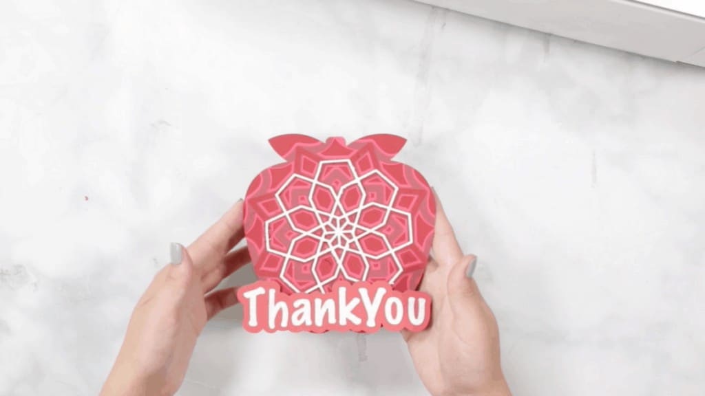 Apple Mandala by popular US craft blog, The Sweetest Thing: image of a woman holding a layered apple mandala. 