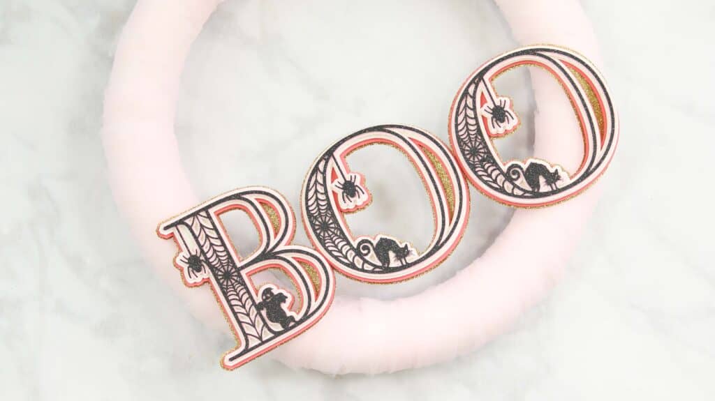 Paper Wreath by popular US craft blog, Sweet Red Poppy: image of a white tulle wreath with 3D letters that spell the word boo. 