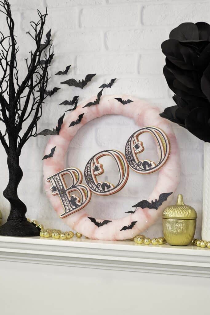 Paper Wreath by popular US craft blog, Sweet Red Poppy: image of a Halloween wreath with pink tulle, layered 3D letters, and black paper bats. 