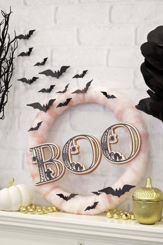 Paper Wreath by popular US craft blog, Sweet Red Poppy: image of a Halloween wreath with pink tulle, layered 3D letters, and black paper bats. 