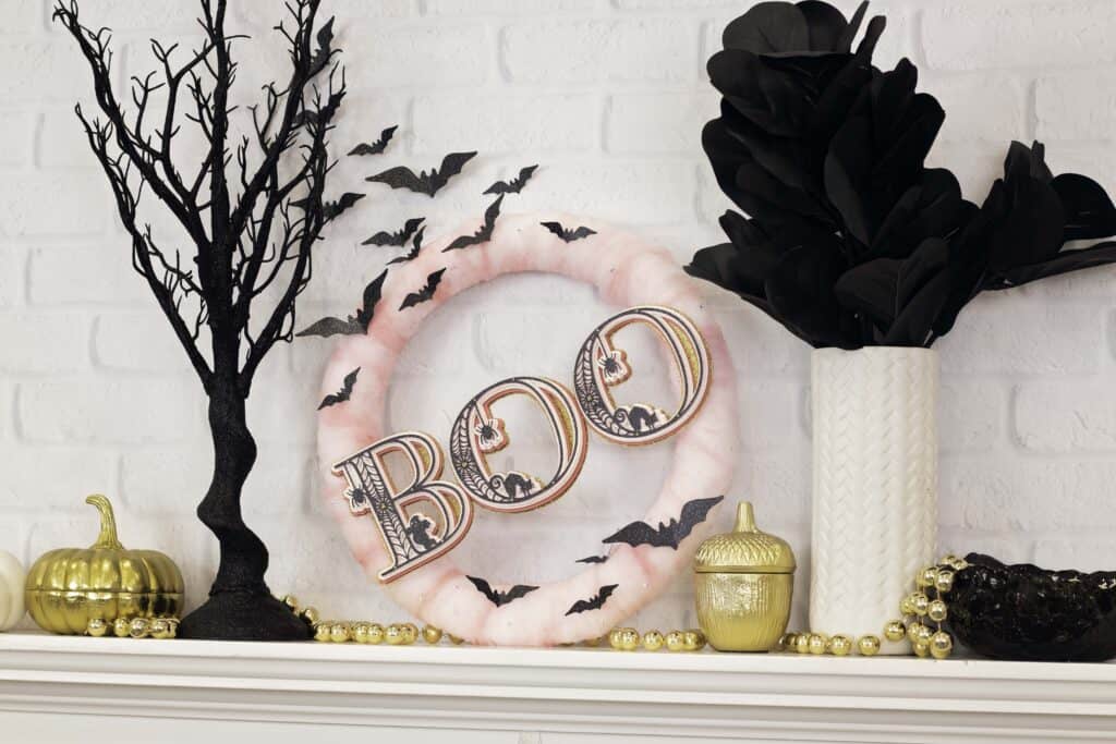 Paper Wreath by popular US craft blog, Sweet Red Poppy: image of a Halloween wreath with pink tulle, layered 3D letters, and black paper bats. 