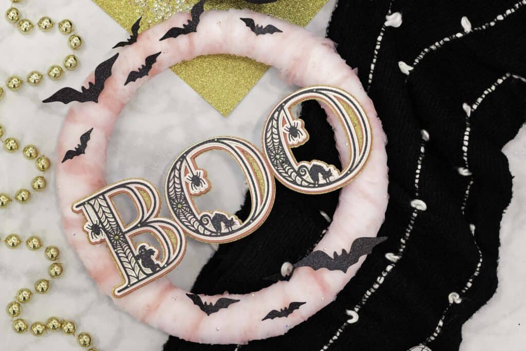 Paper Wreath by popular US craft blog, Sweet Red Poppy: image of a Halloween wreath with pink tulle, layered 3D letters, and black paper bats. 