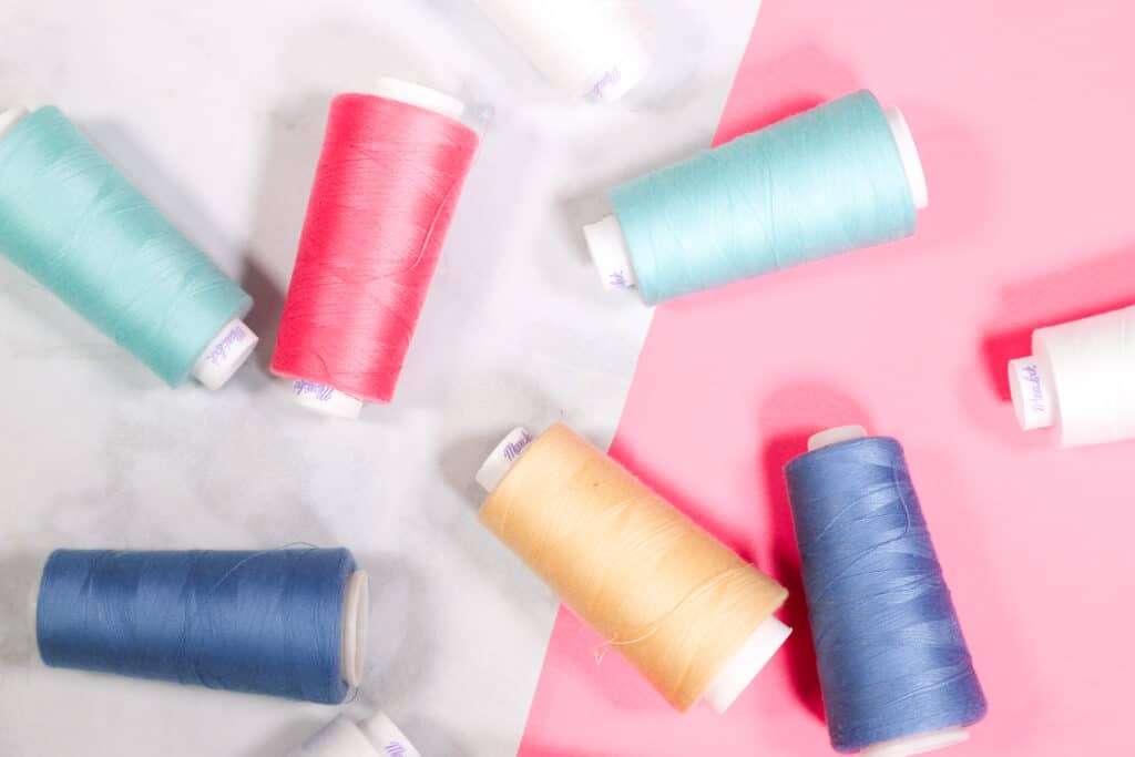 How many threads does a serger have? | Serger VS Sewing Machine by popular US sewing blog, Sweet Red Poppy: image of serger thread cones.