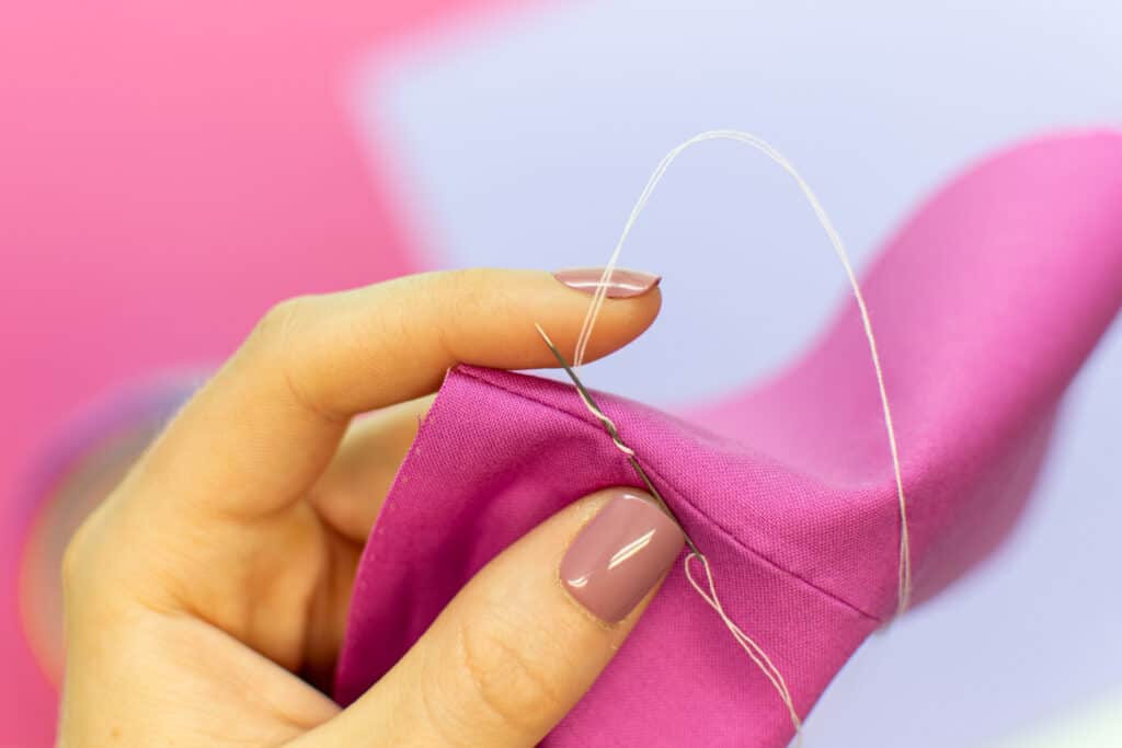 wrap the thread around the hand sewing needle