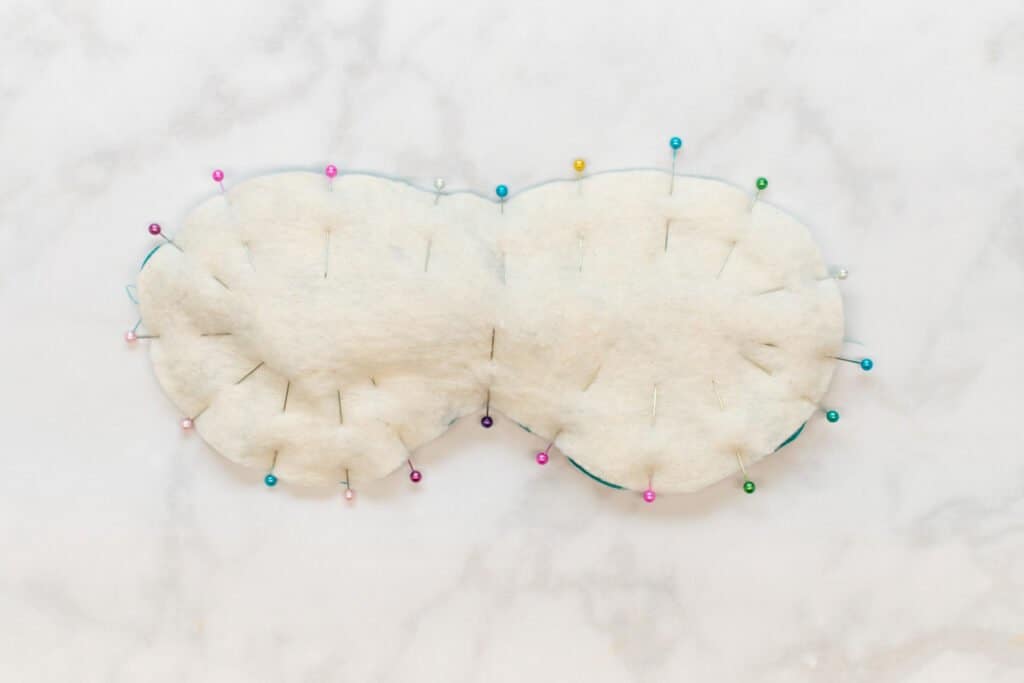 pin the outer edge of the sleep mask through all layers