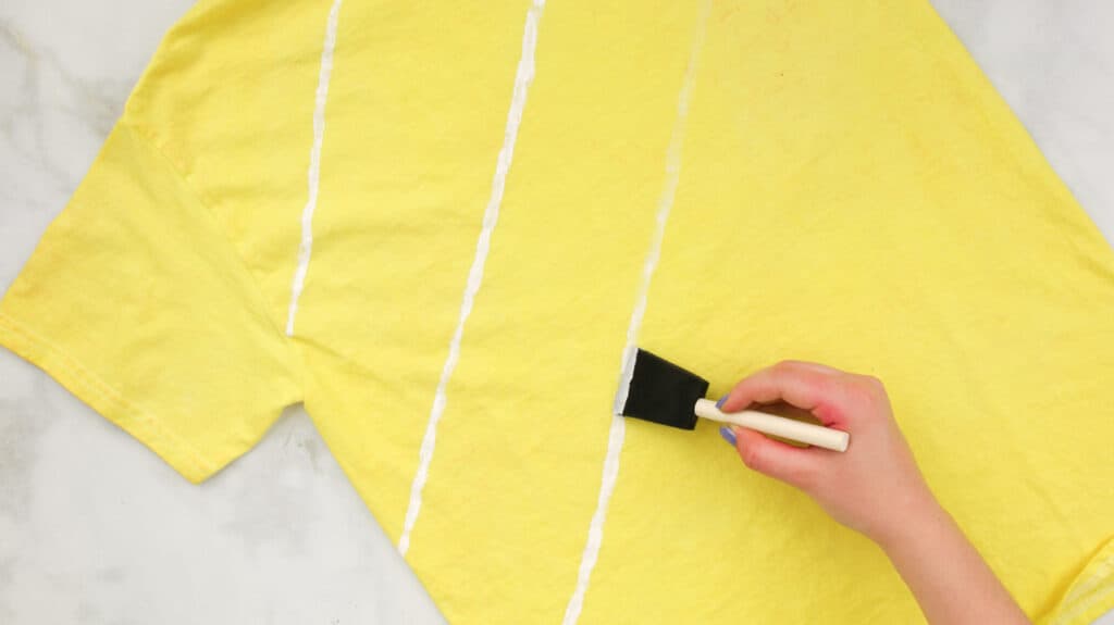 Painting White Diagonal Stripes on Yellow Tie Dyed T-Shirt