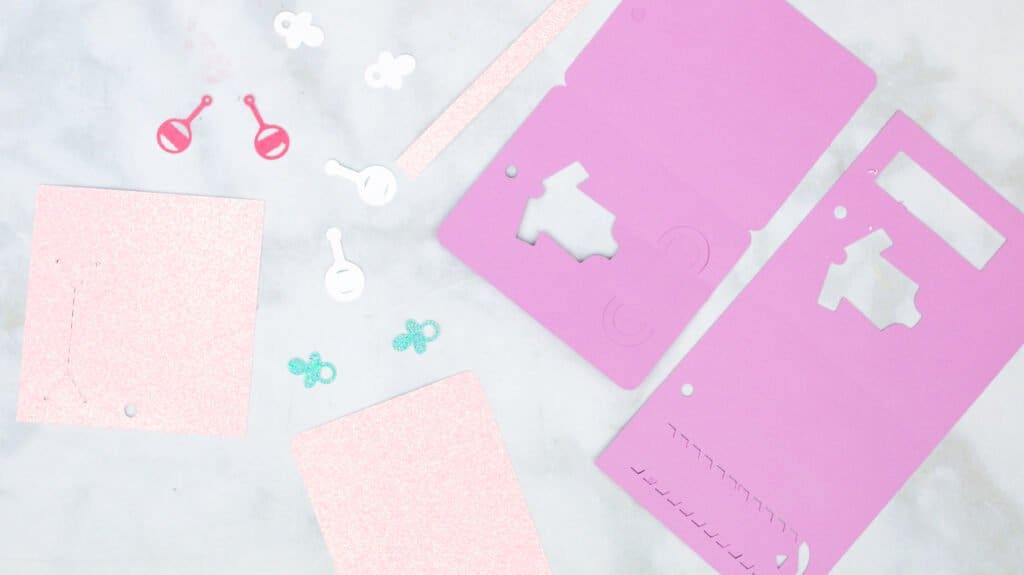 Cut out pieces of baby shower gift card holders