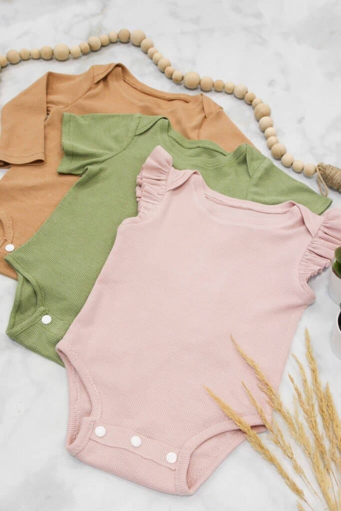 Sew a Baby Bodysuit With This Beginner-Friendly Step-By-Step Photo Tutorial and Video. Free Sewing Pattern in 9 Different Sizes.