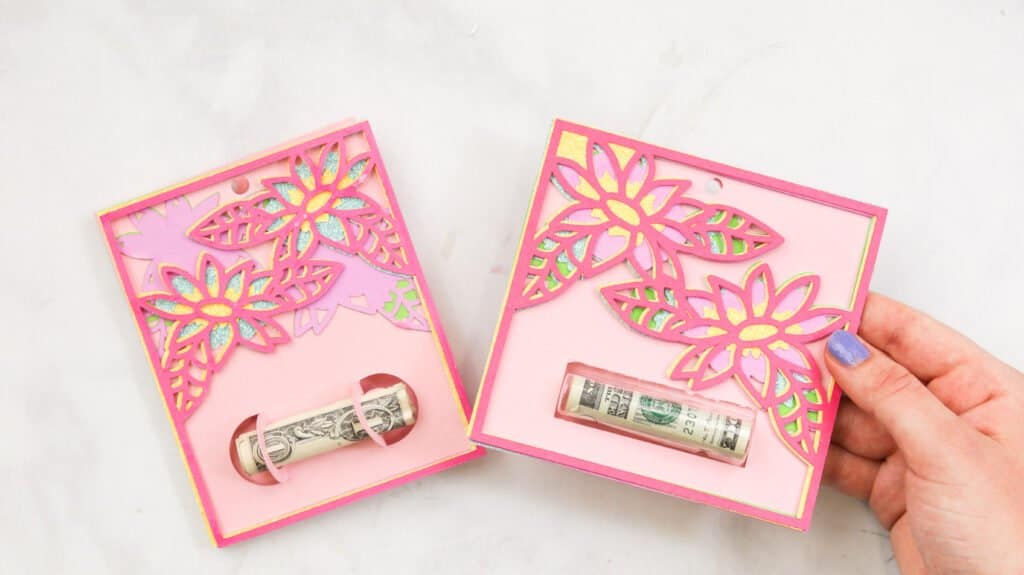 Showing two finished versions of layered flower gift card holders