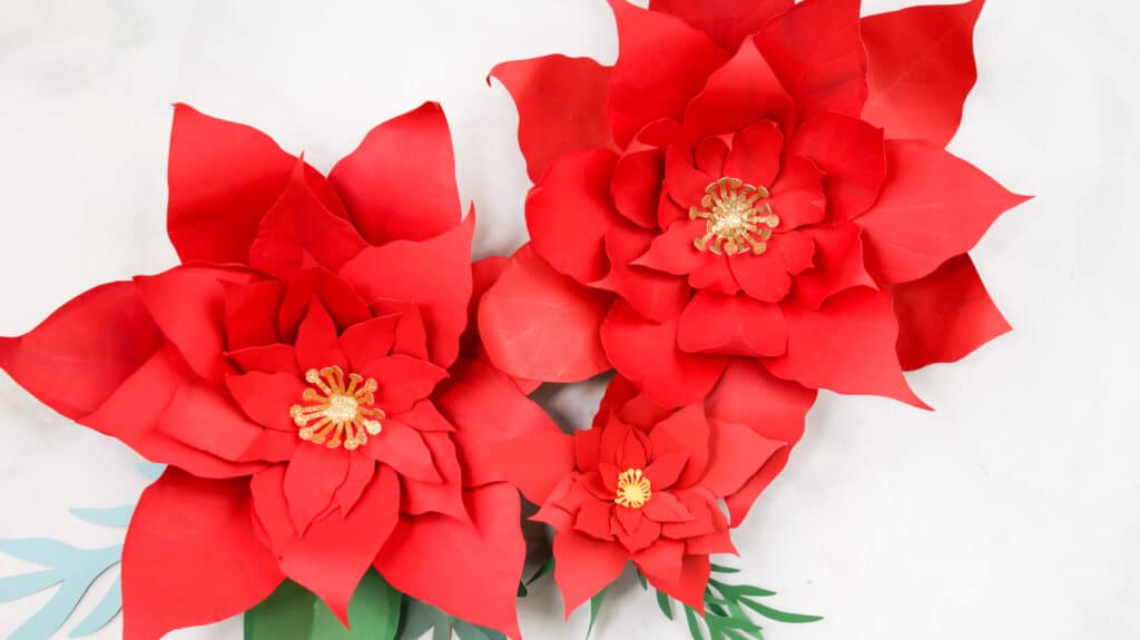 Three finished Poinsettia Paper Flowers.