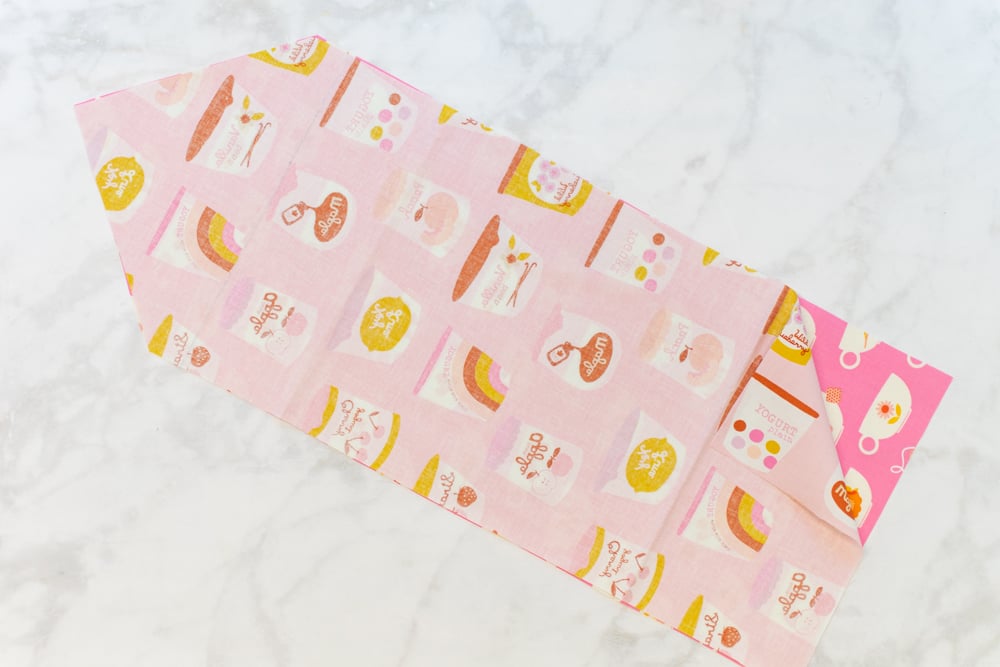 two pink fabrics with food-related prints stacked on top of each other