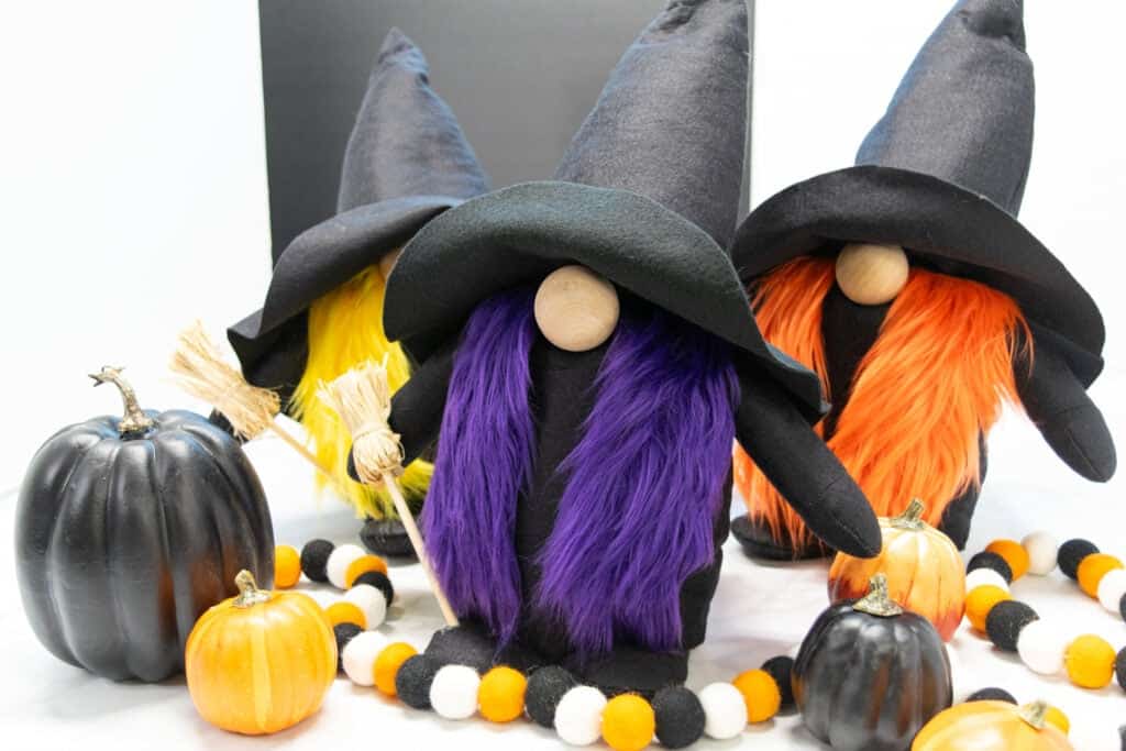 3 completed sanderson sisters witch gnomes with black and orange pumpkins