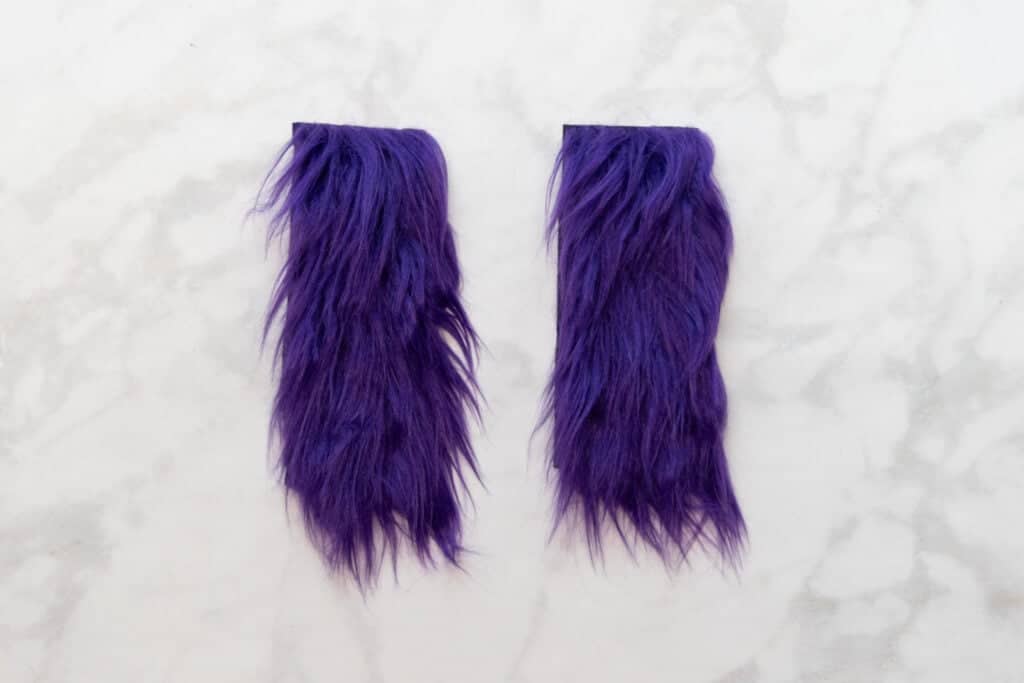 2 pieces of purple faux fur with the fur brushed towards the bottom