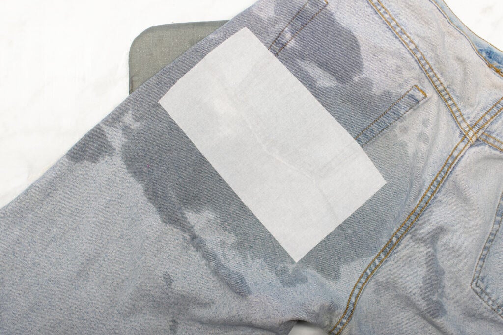 a piece of fusible interfacing fused to cover a rip in jeans
