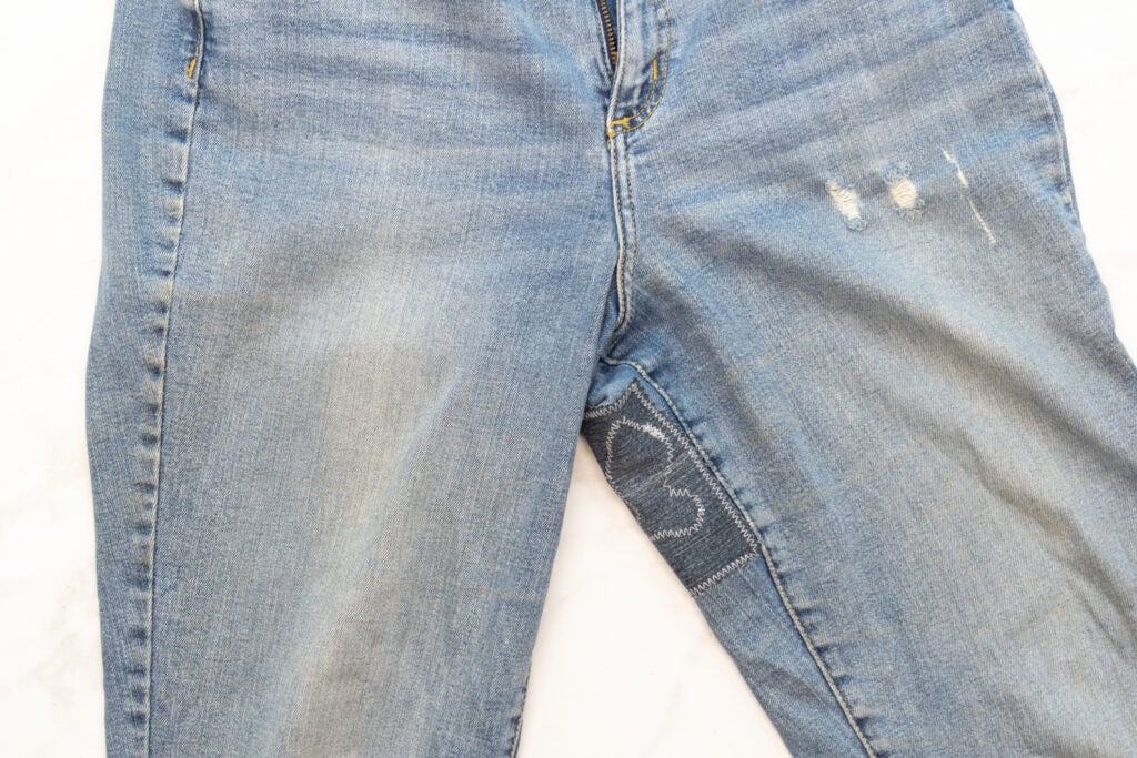 a rip in jeans mended with a denim patch