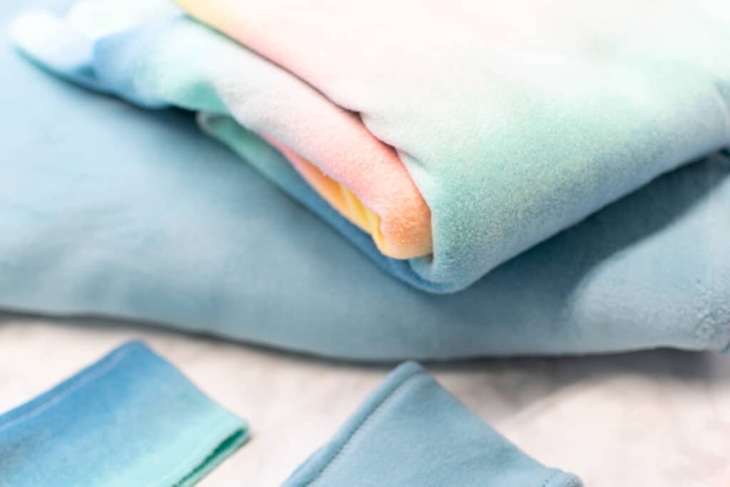 a close up of a stack of folded fleece fabrics