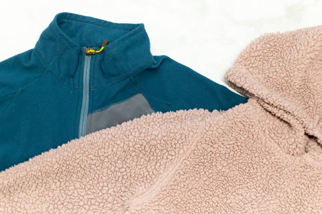 a fleece zip-up jacket and a sherpa sweater