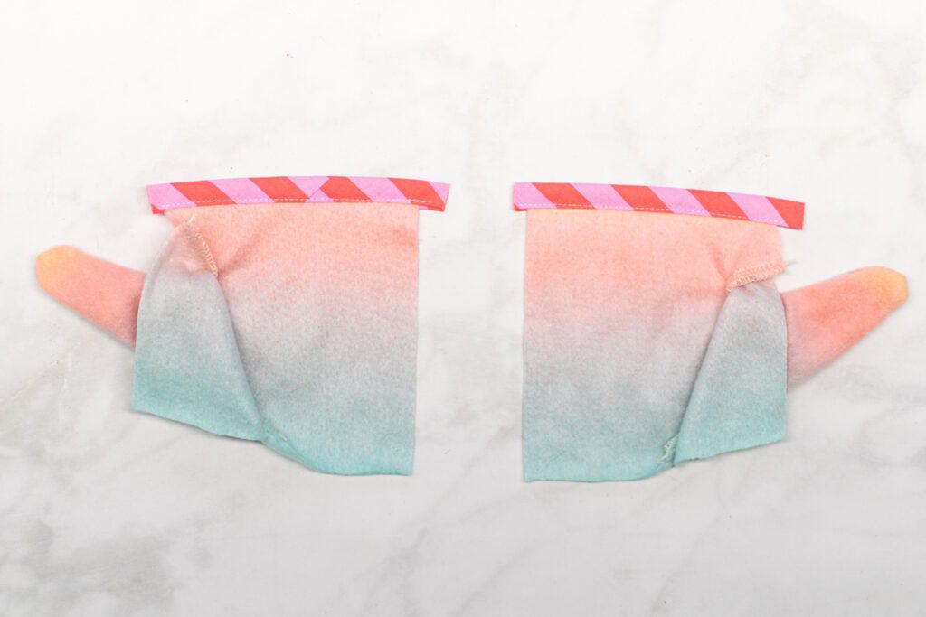 a piece of pink striped bias tape is topstitched to the top of each Front Bottom piece with white thread