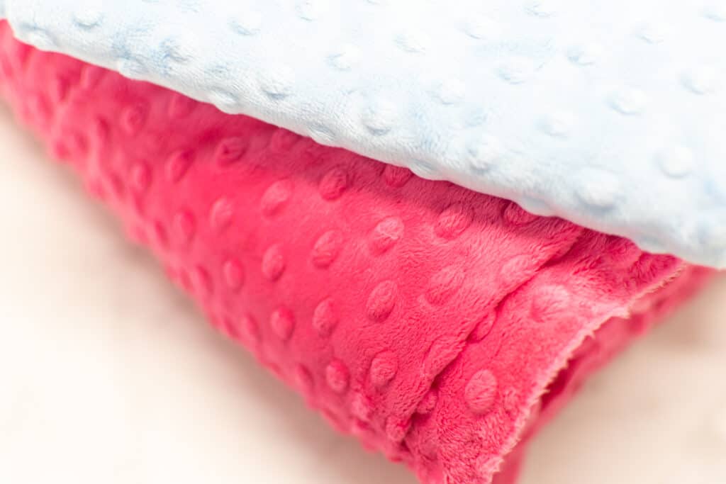 bright pink and light blue minky dot fabrics stacked