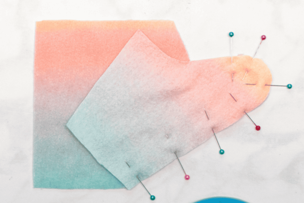 some fabric pieces pinned together with multicolored pins