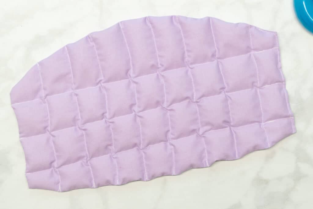 the open short end of the heating pad is topstitched closed with white thread