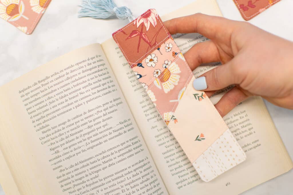 a closeup of a diy pieced bookmark in a book