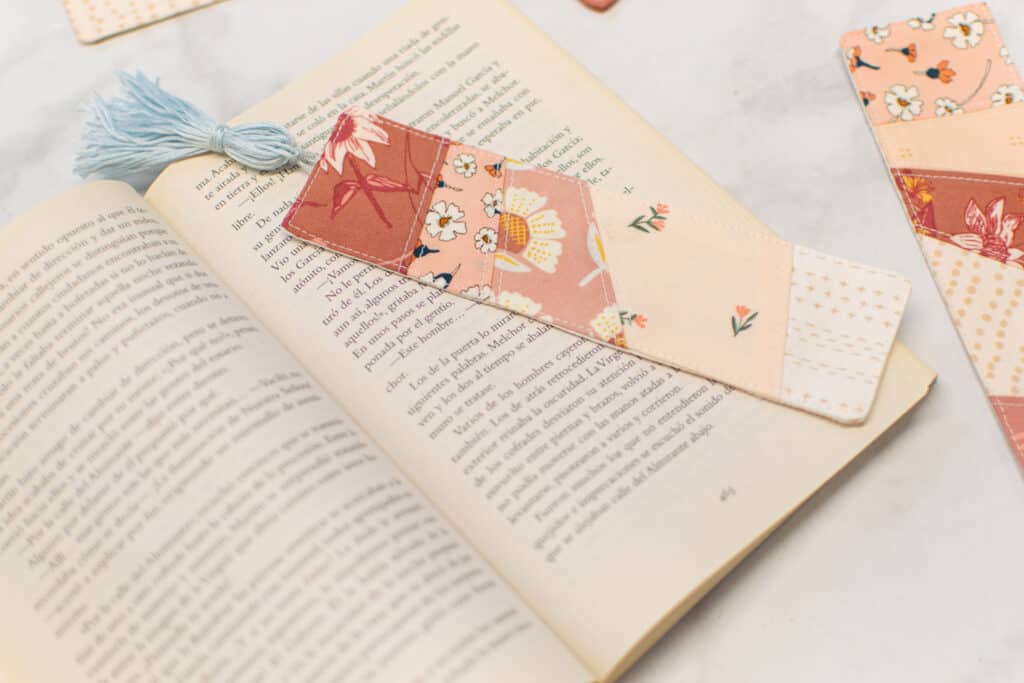 diy pieced bookmark with a tassel in a book