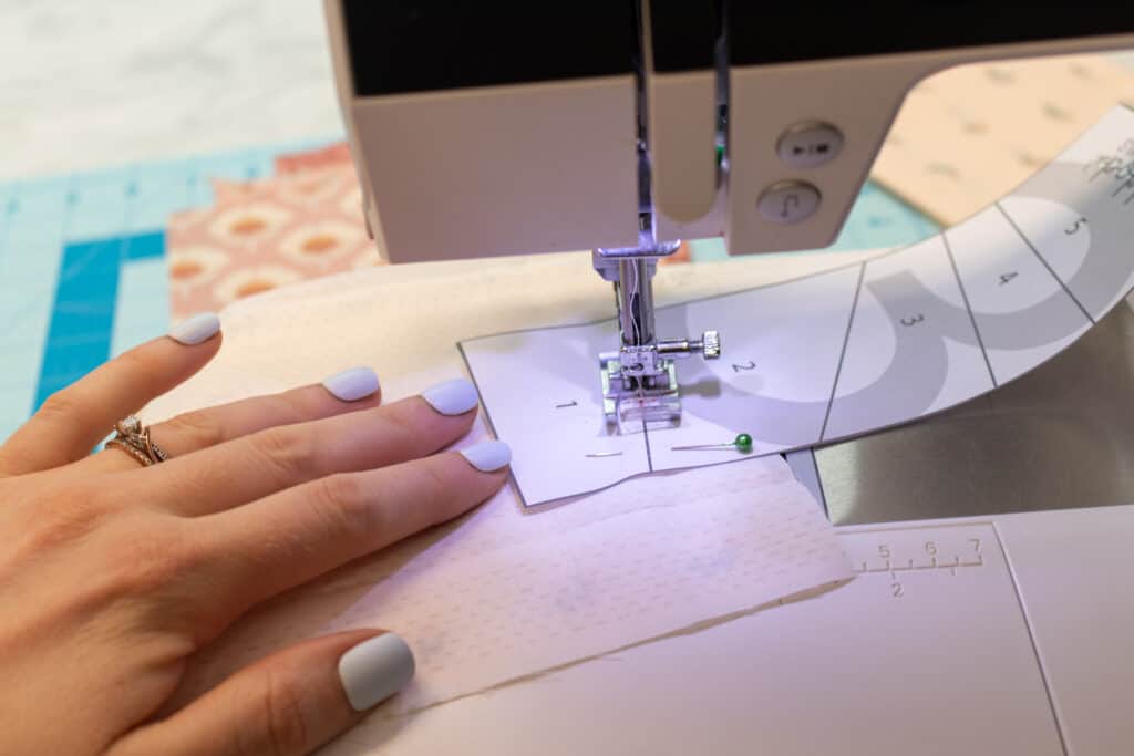 close up of a sewing machine sewing the first FPP seam